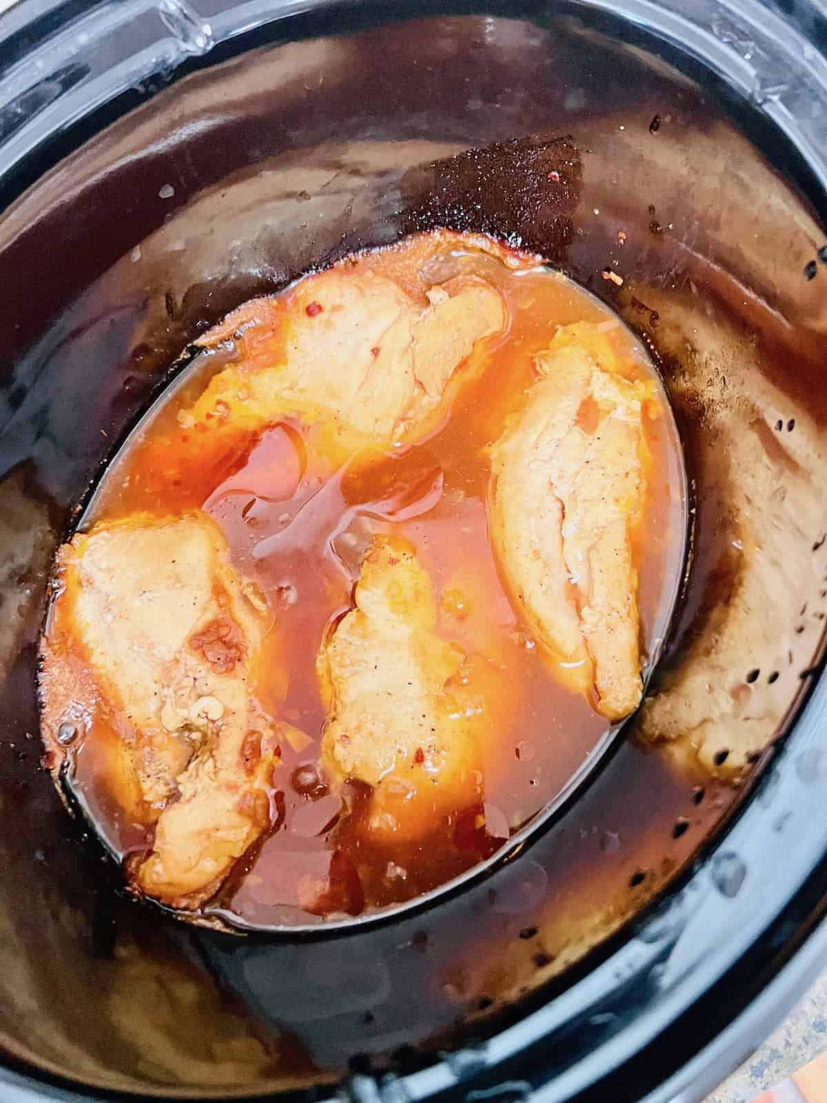 Slow Cooker BBQ Pulled Chicken Cooked boneless skinless breasts in vinegar bbq sauce.