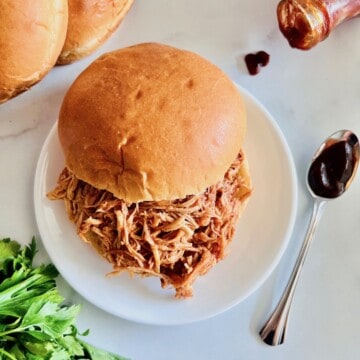 Slow Cooker BBQ Pulled Chicken on a soft roll.