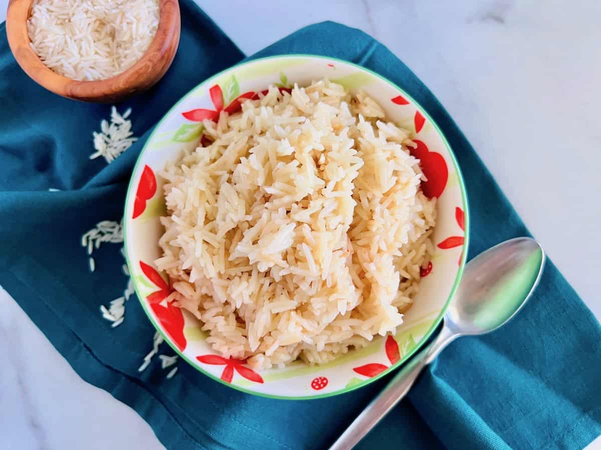 Rice cooked in chicken broth in a bowl. 