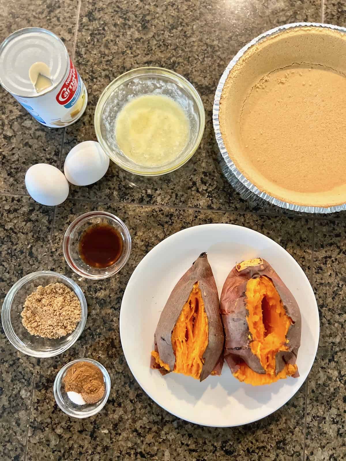 Pie Baked sweet potatoes next to other ingredients on a counter.