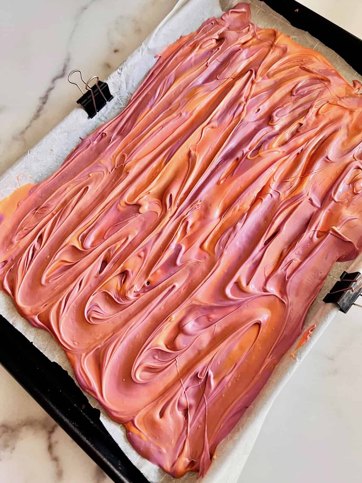 Parchment paper topped with melted candy.
