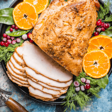 Boneless turkey breast sliced on a serving platter.