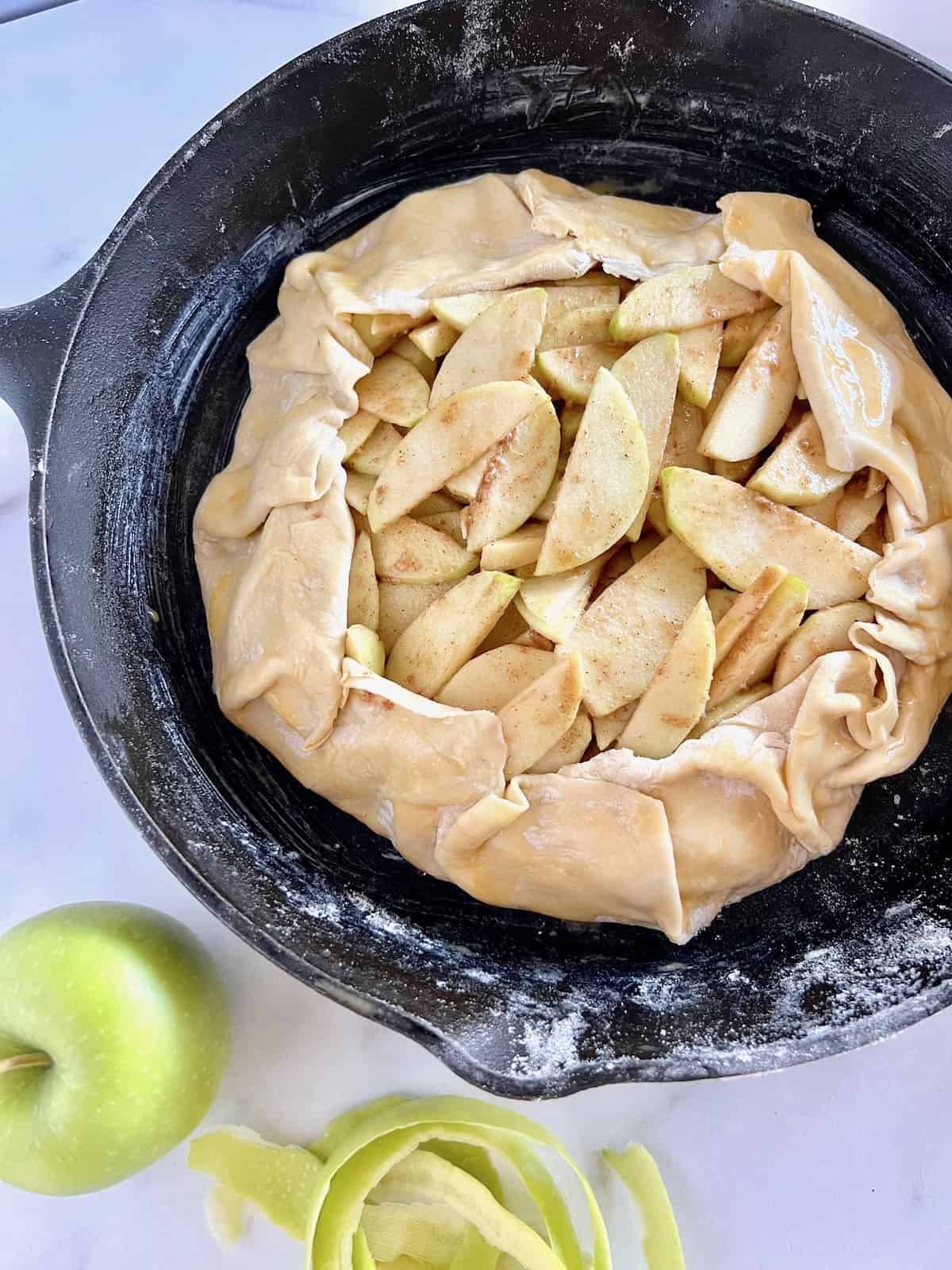 Puff Pastry Apple Galette Raw with folded edges and apples in the middle.