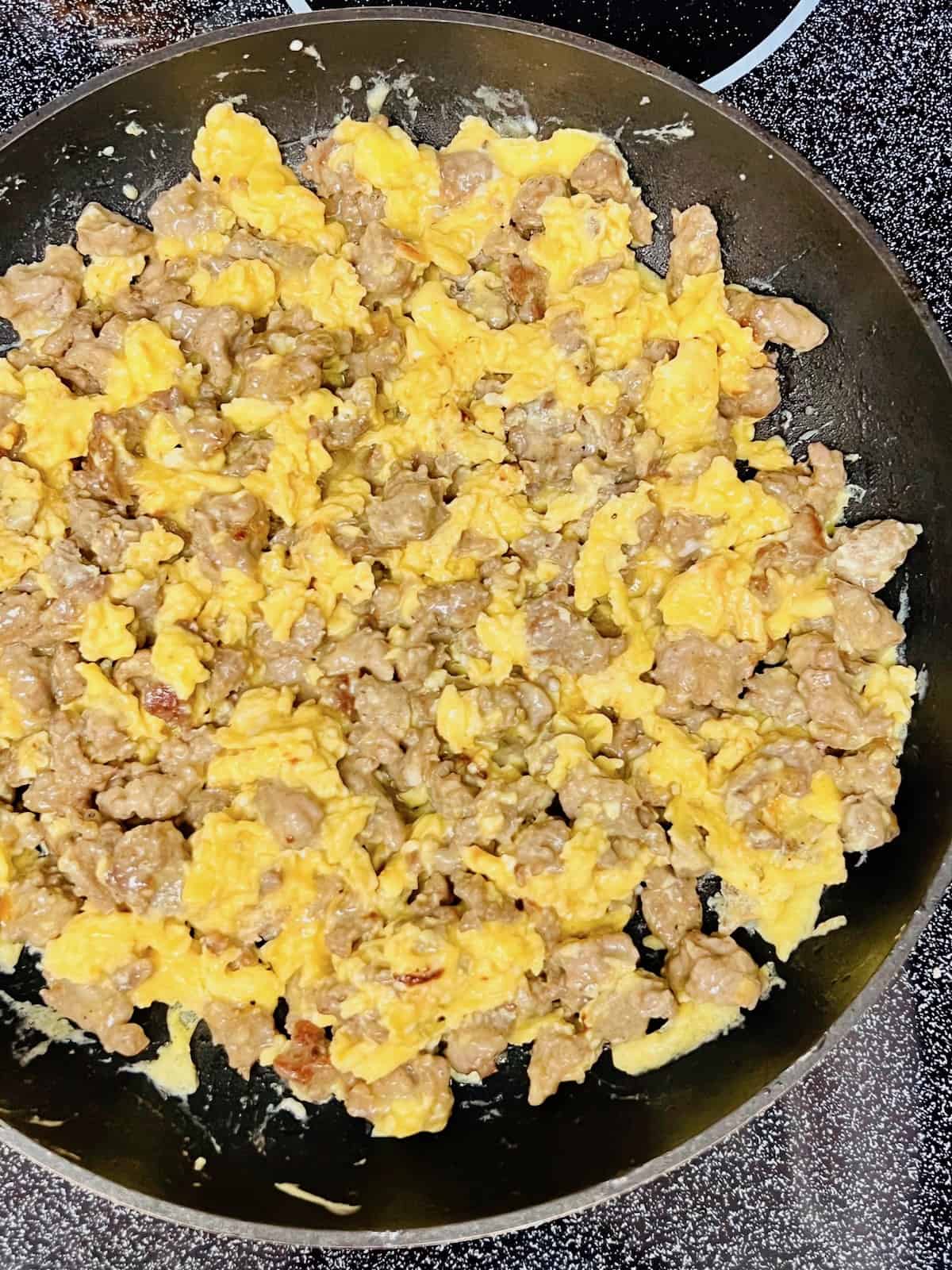 Breakfast Sausage, Egg, & Cheese Scramble Crumbled sausage and eggs cooked in the skillet.