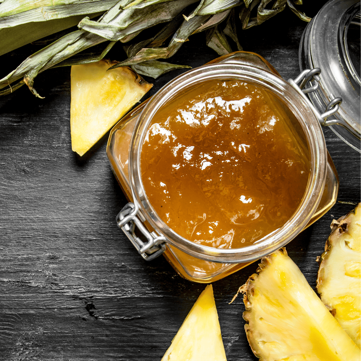 A jar filled with ham glaze made from pineapple and brown sugar.