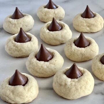 Homemade Hershey's Kiss Sugar Cookies cooling on the counter.