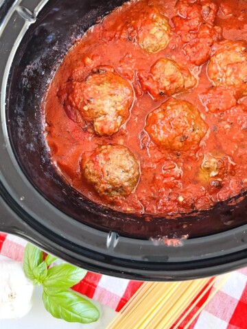 Crockpot filled with Slow Cooked Italian Beef Meatballs & Tomato Sauce
