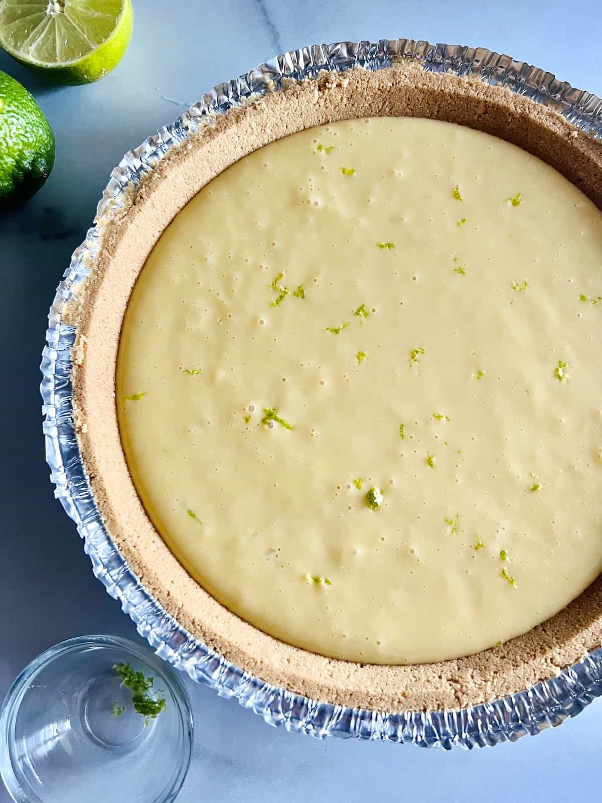 Pie Crust filled with key lime filling and topped with a sprinkle of zest.