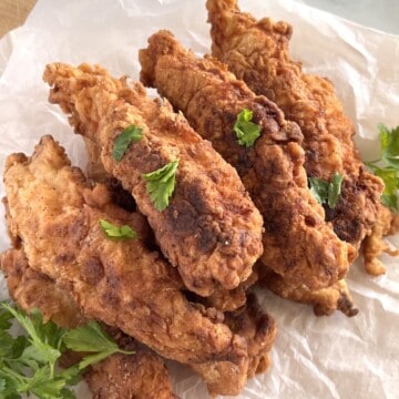 Stack of buttermilk marinade chicken tenders battered and fried.