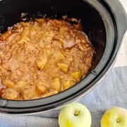 Crockpot filled with apples & cobbler topping.
