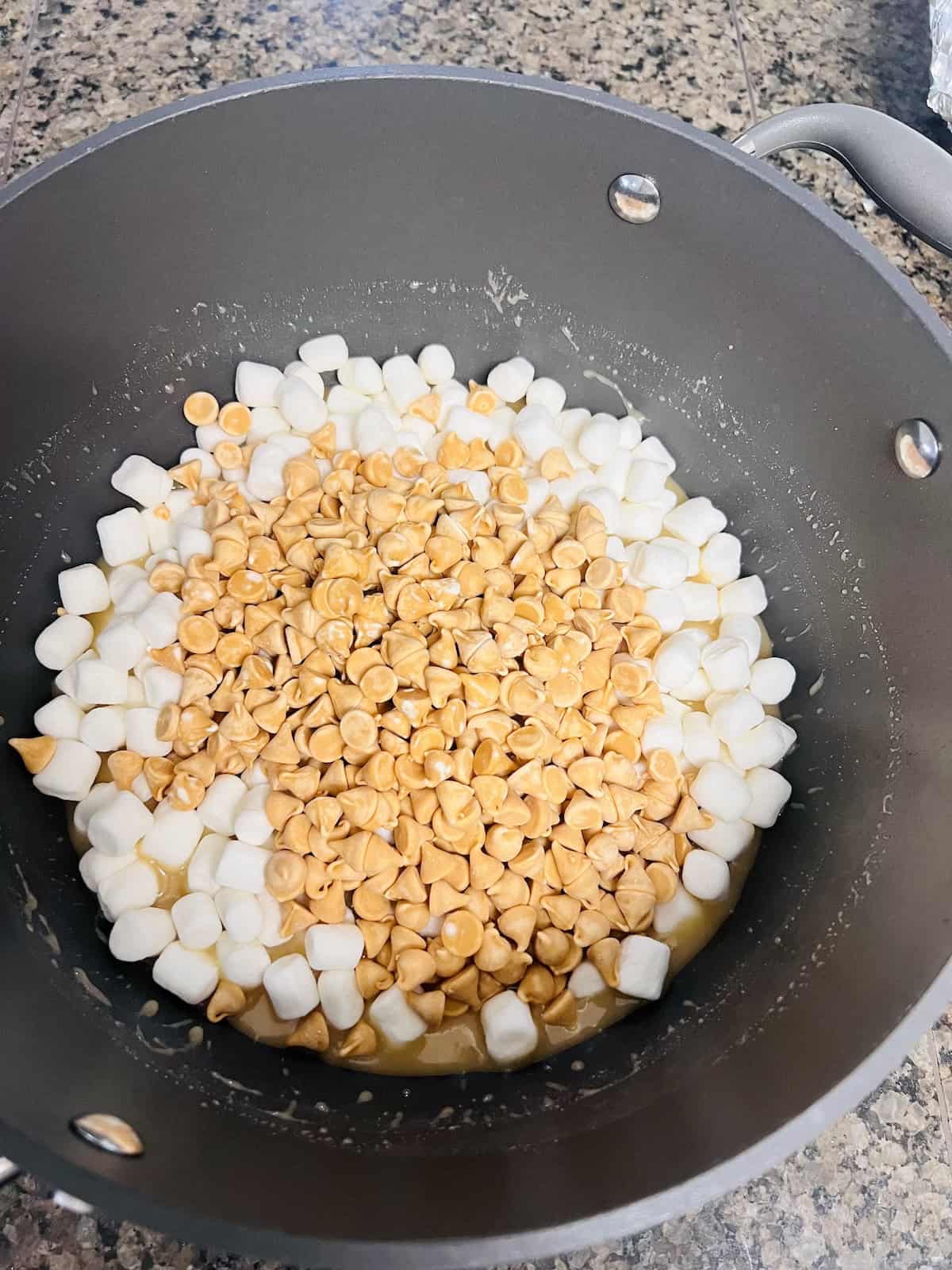 Adding marshmallows and butterscotch chips to the pot.