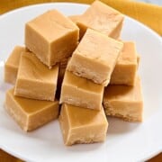 Plate full of creamy butterscotch fudge cut into squares.
