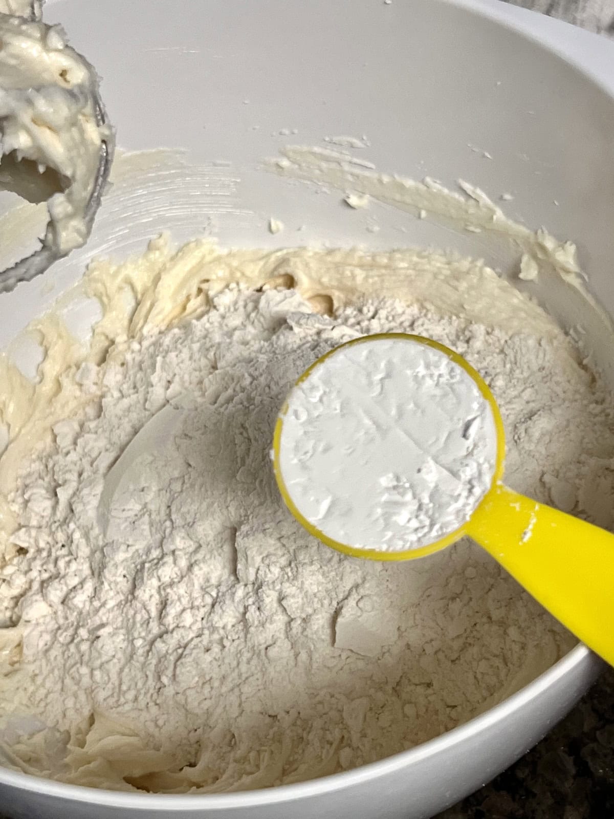Adding dry ingredients including cornstarch for melt in your mouth shortbread texture.