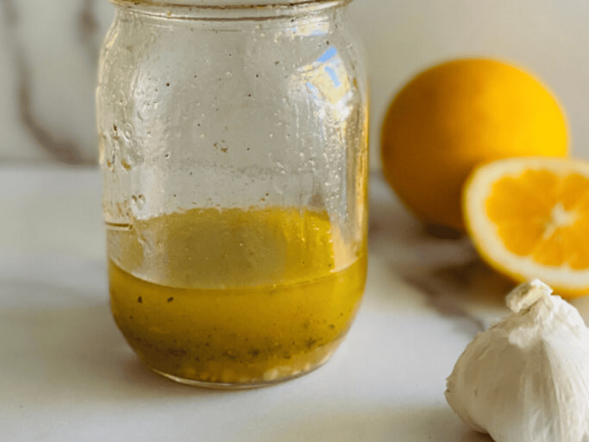 Mason jar with homemade lemon pepper marinade for chicken, fish, or meat.