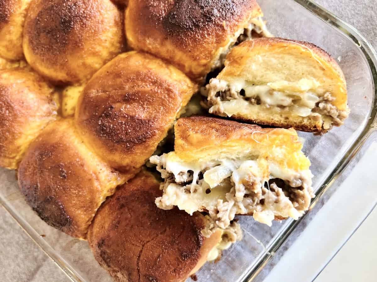 Philly Cheesesteak Sliders on Hawaiian Rolls Best Recipe with shaved beef provolone and onions.