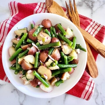 Bowl of Italian Green Bean and Potato Salad with vinaigrette and no mayo.