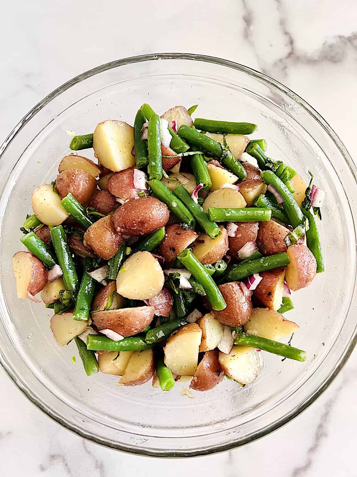 Italian Green Bean and Potato Salad Tossed with herbs onions and oil vinegar dressing.