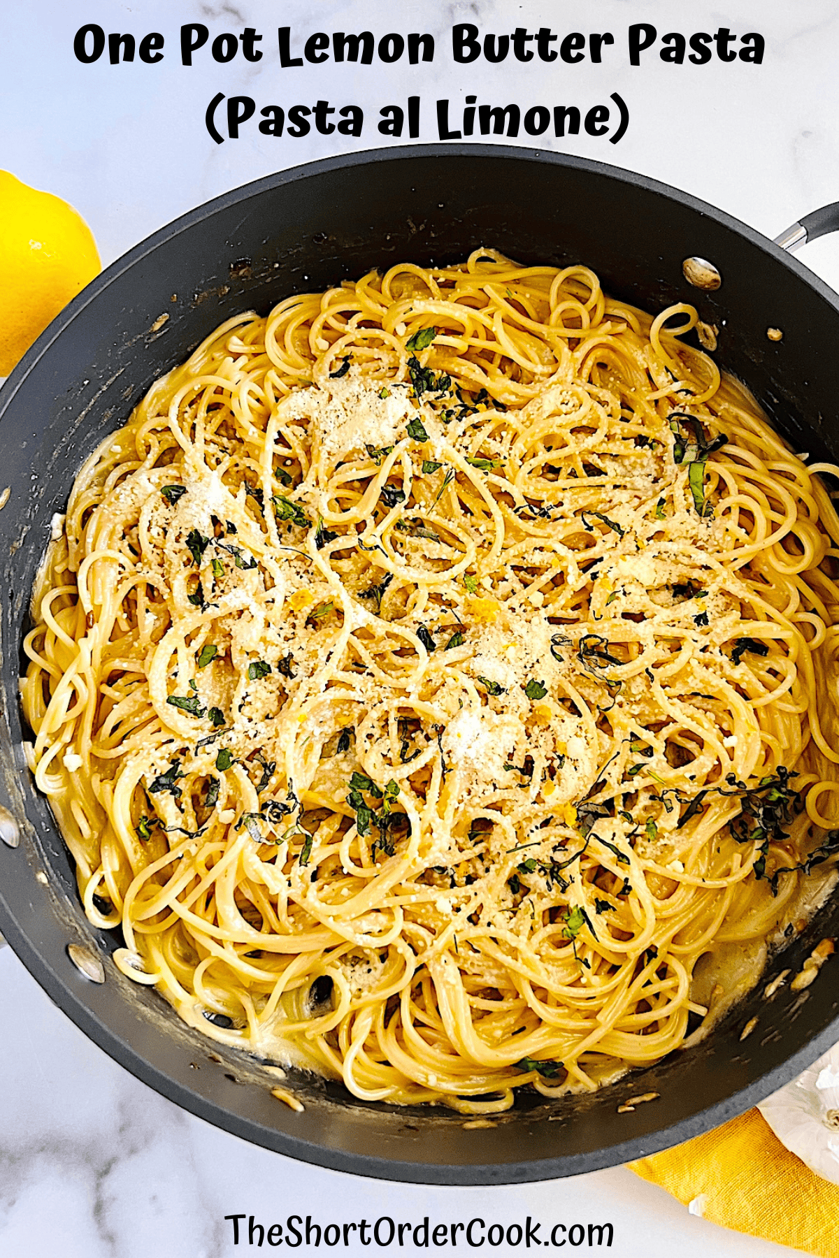Pot filled with pasta al limone made with spaghetti lemon juice, zest, garlic, olive oil, butter, fresh basil, and parmesan.