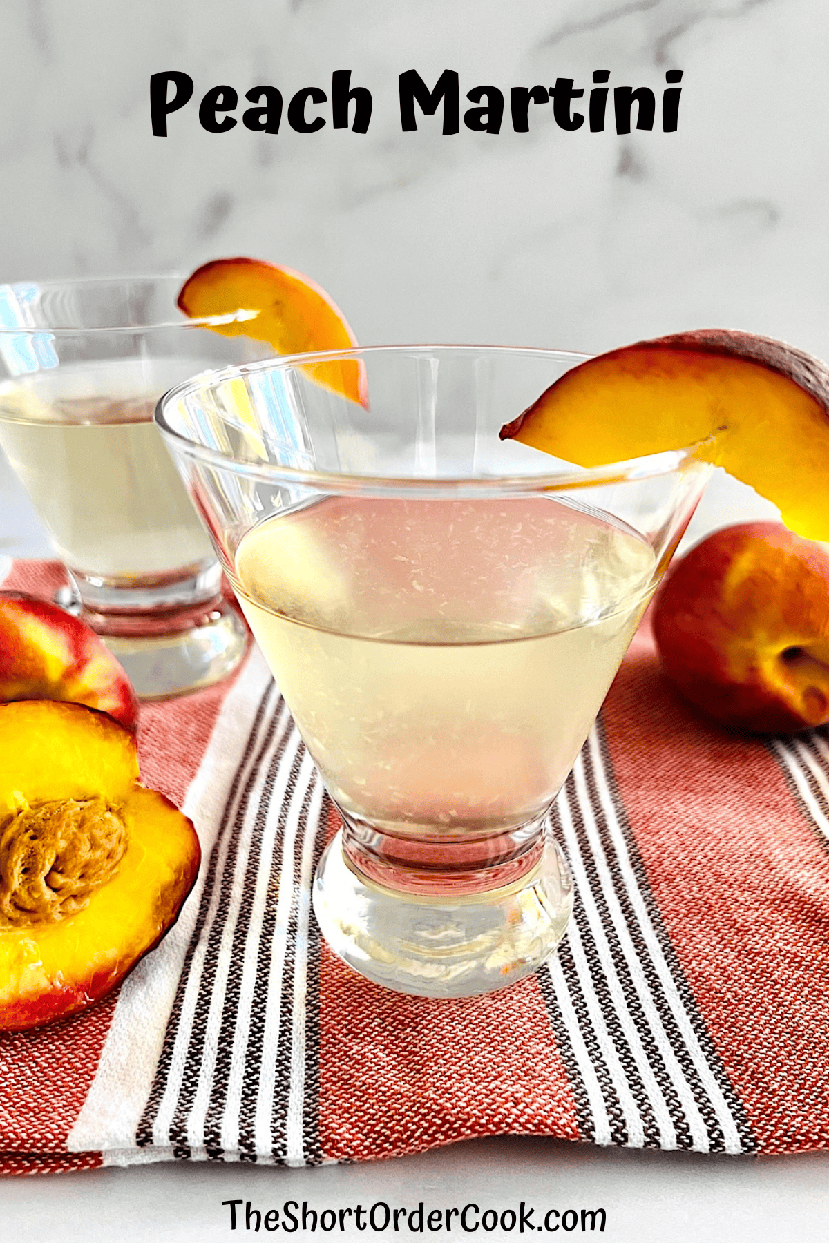 Two glasses with peach vodka martinis.