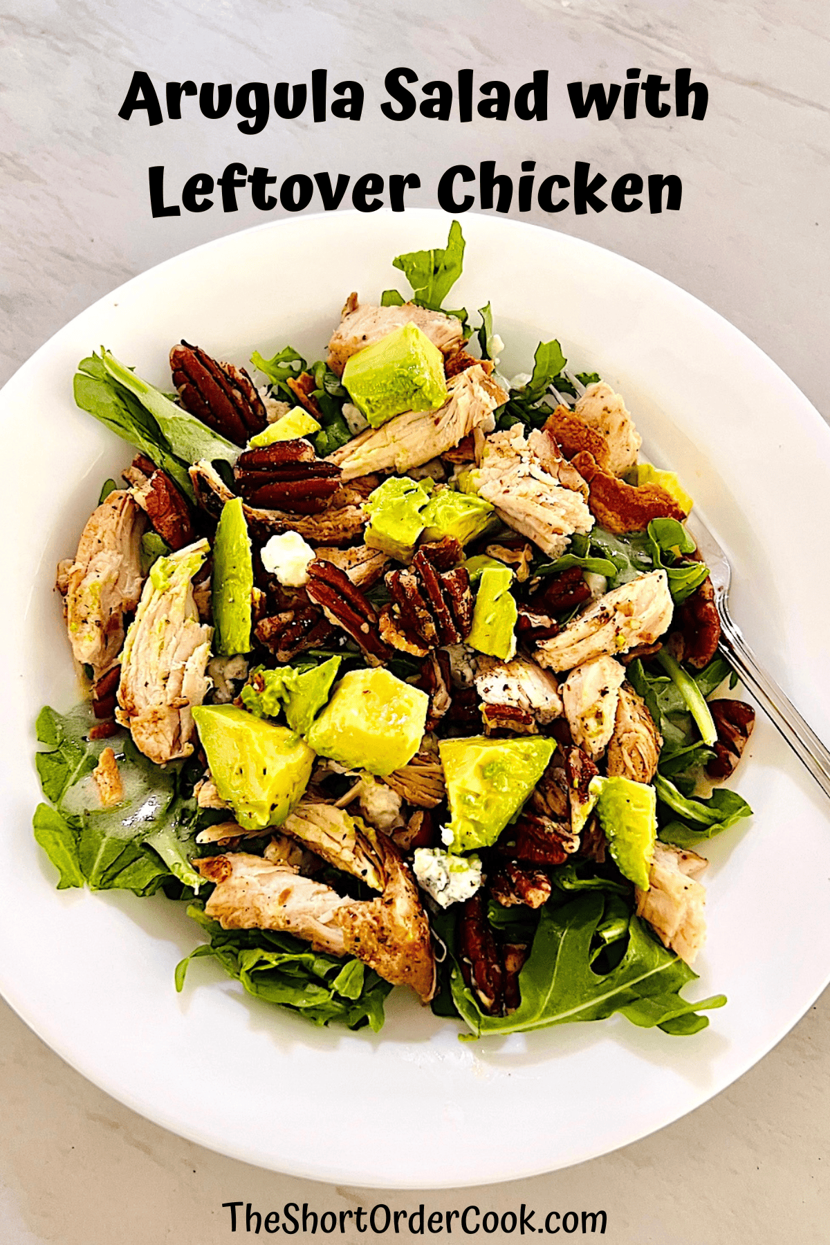 Green salad with leftover chicken, arugula, cheese, nuts, and avocado.