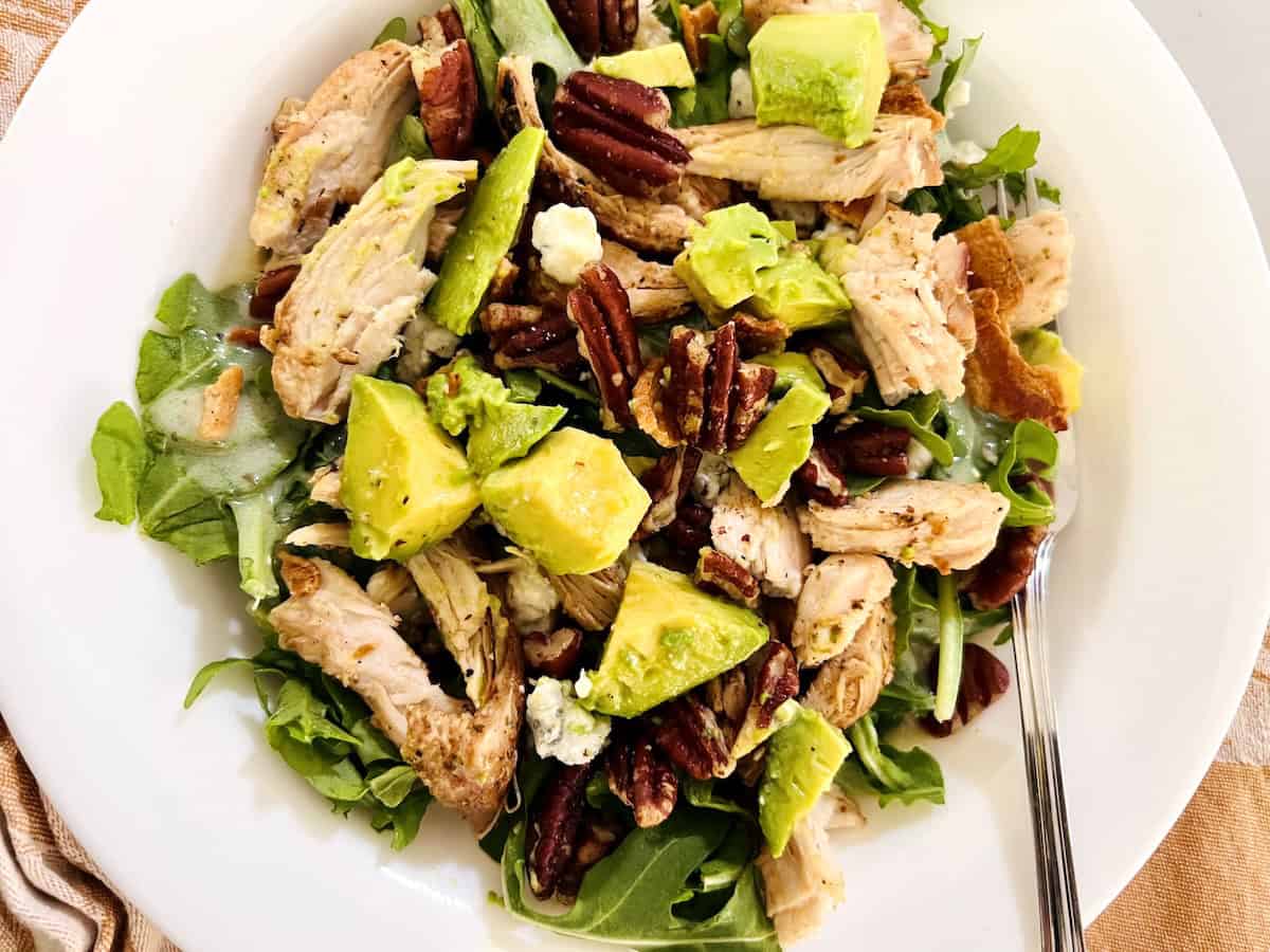 Arugula Salad with Leftover BBQ Chicken, avocado, pecans, and cheese.