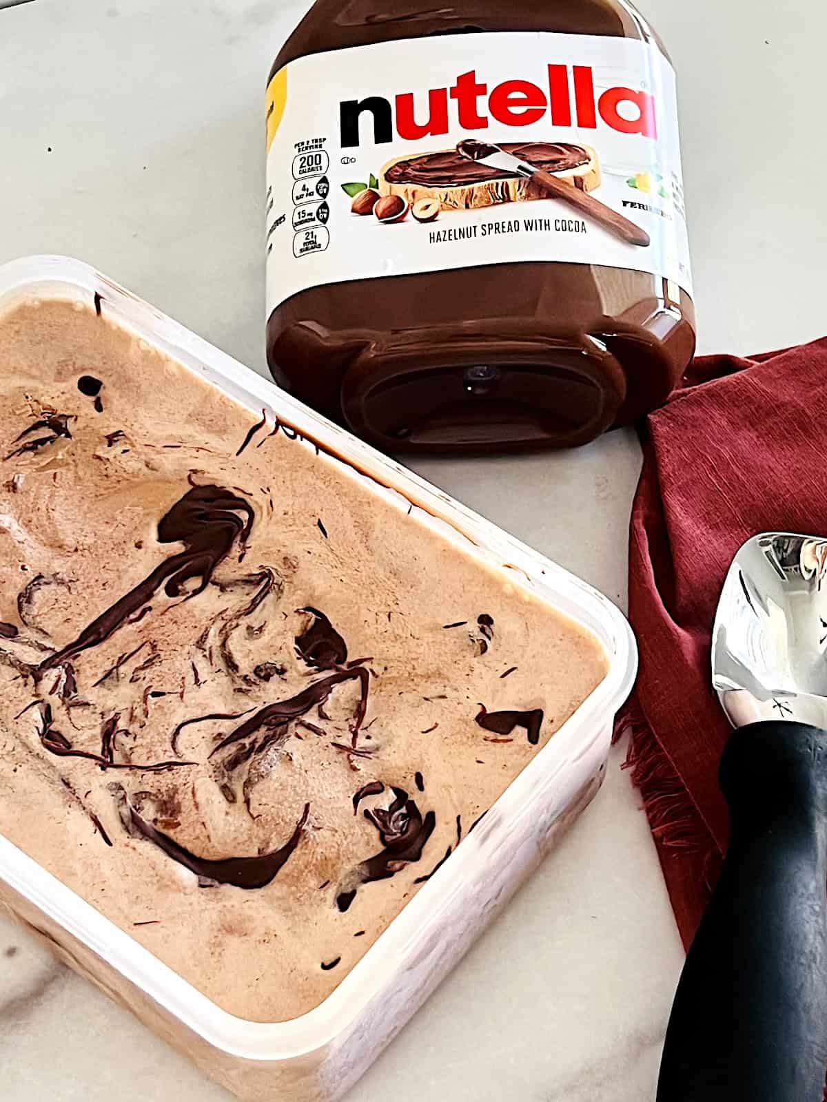 Nutella Ice Cream Frozen in container next to scoop.