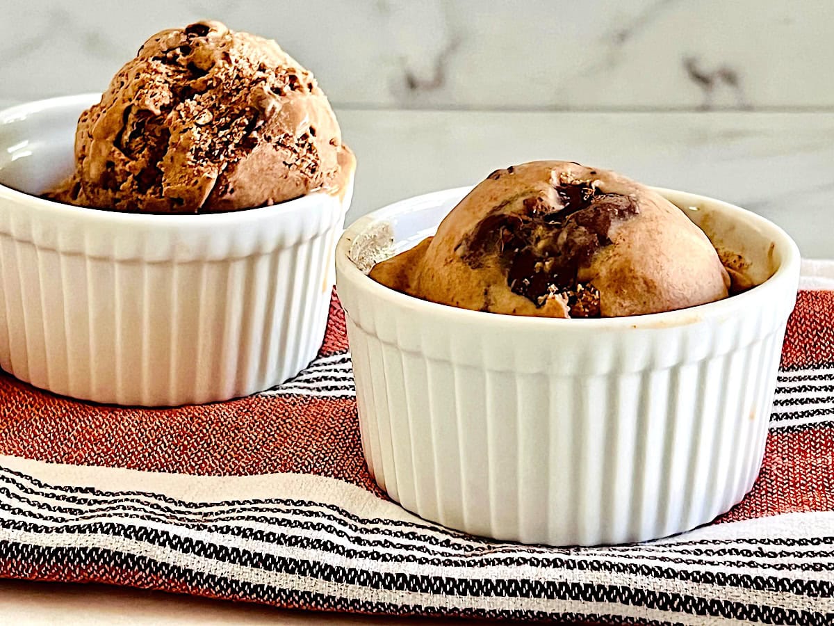 Two white bowls with nutella swirl ice cream.