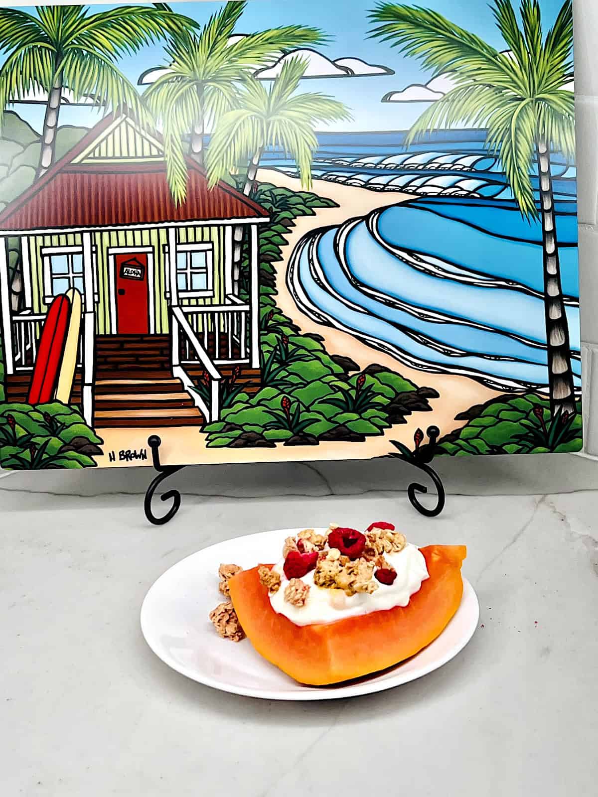 Papaya Yogurt Boats Plated with background Hawaii art.