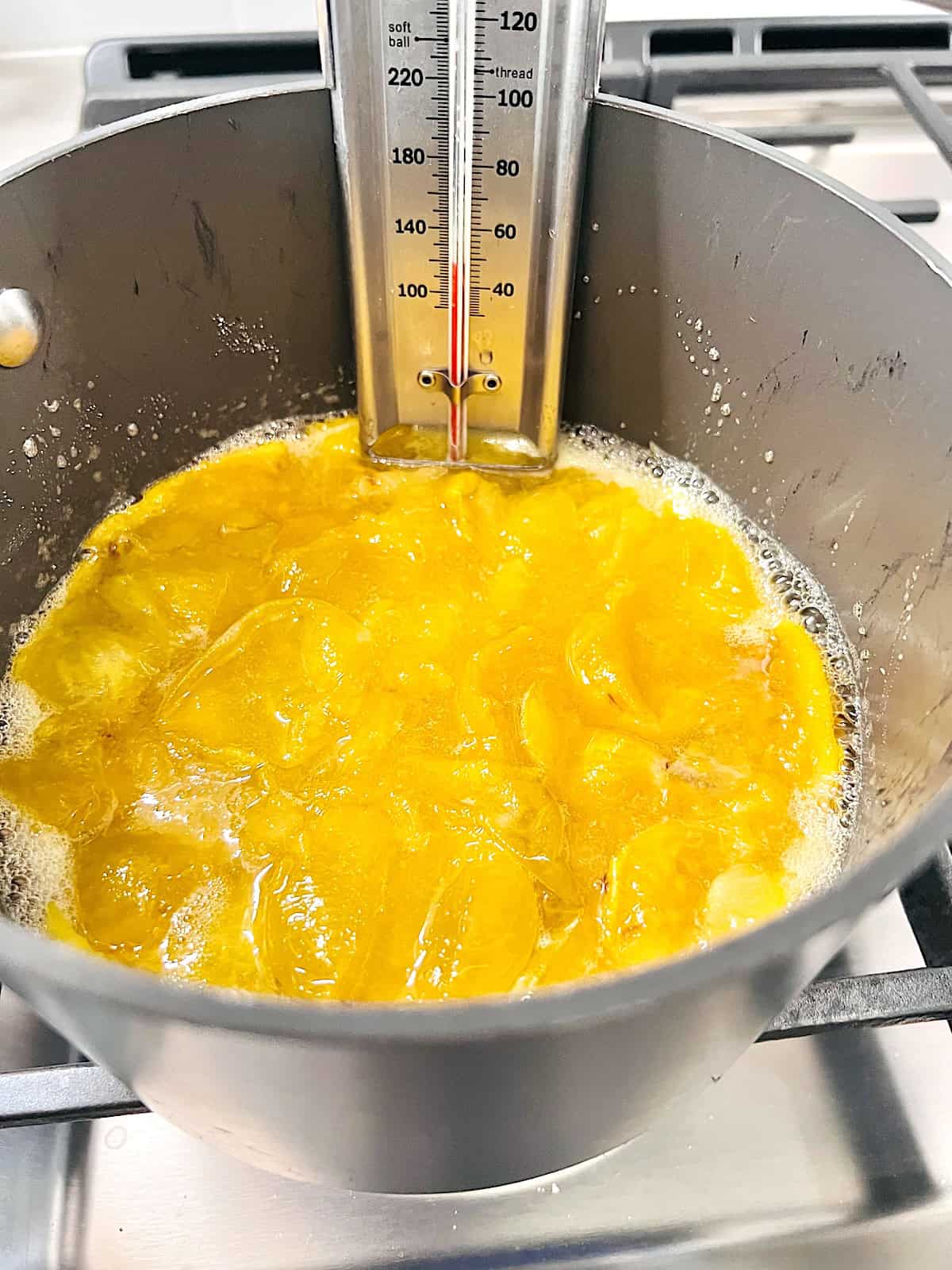 Fresh chunks of plums with sugar and lemon juice in a pot.