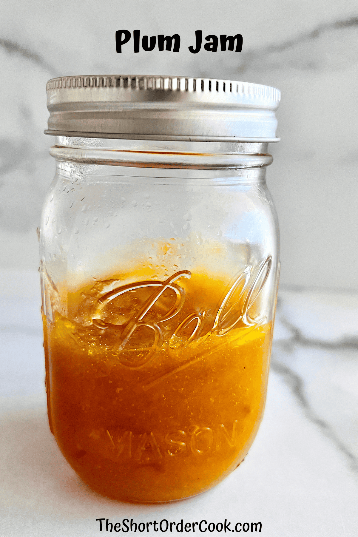 Jar of plum jam made from scratch with real fruit.