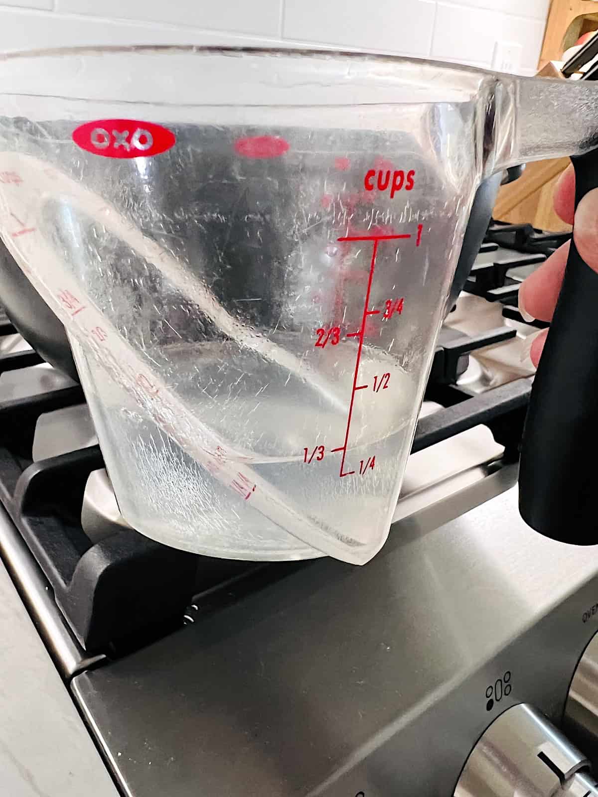 Measuring cup with starchy pasta water.