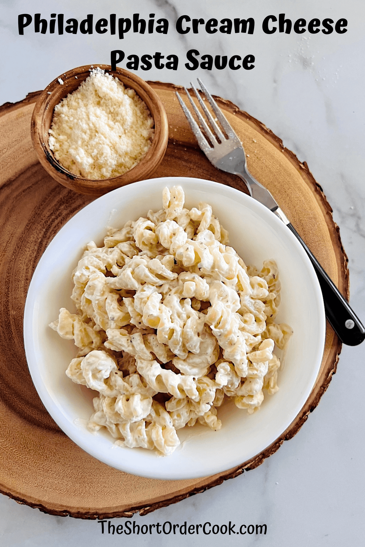 Philadelphia Cream Cheese Pasta Sauce in a bowl served next to grated cheese for topping.