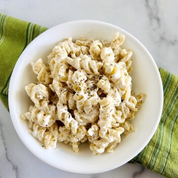 Philadelphia Cream Cheese Pasta Sauce tossed with rotini pasta in a bowl.