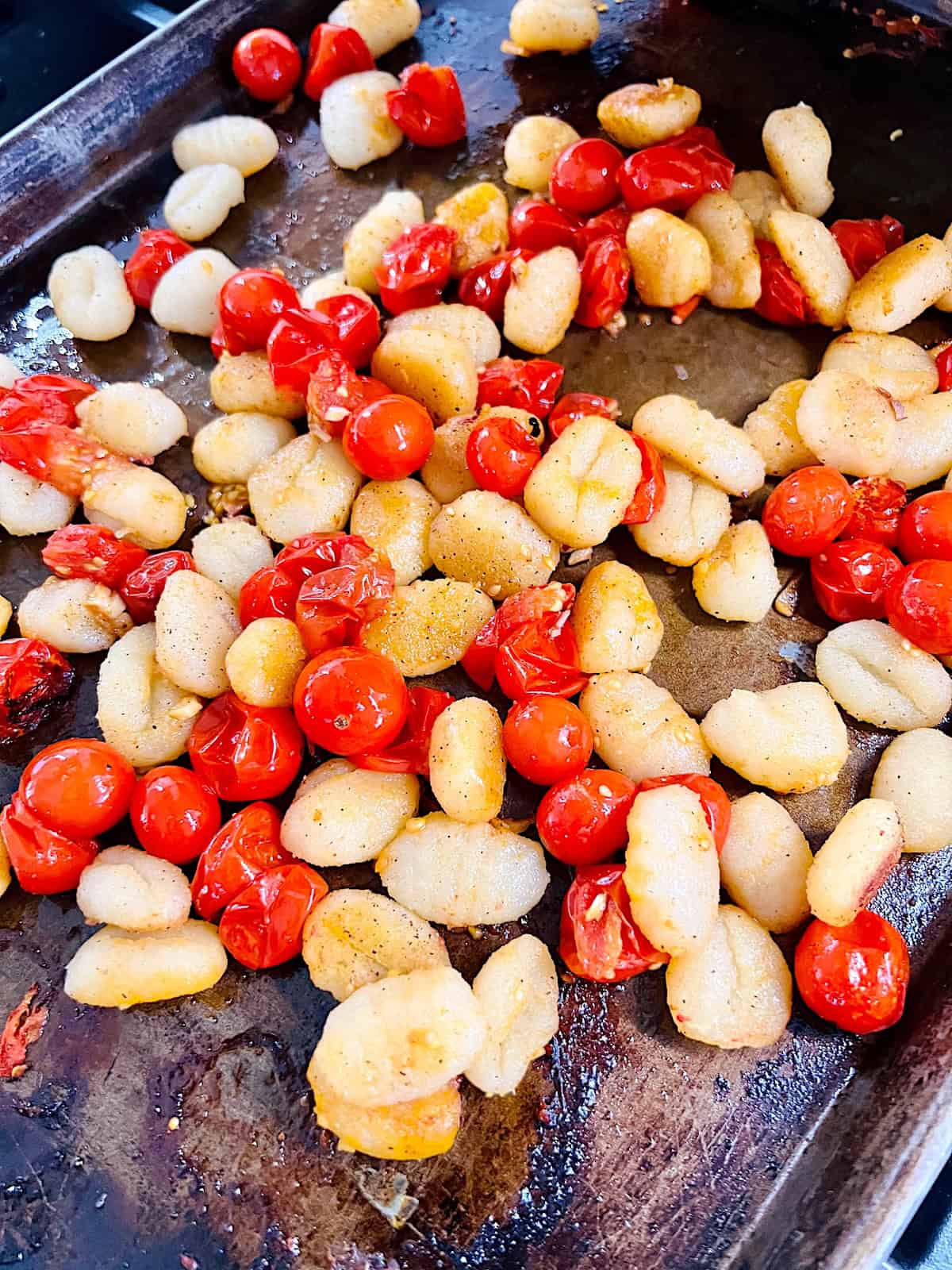 Tomato Basil Gnocchi Half way done cooking in the oven and ready to stir and roast more.