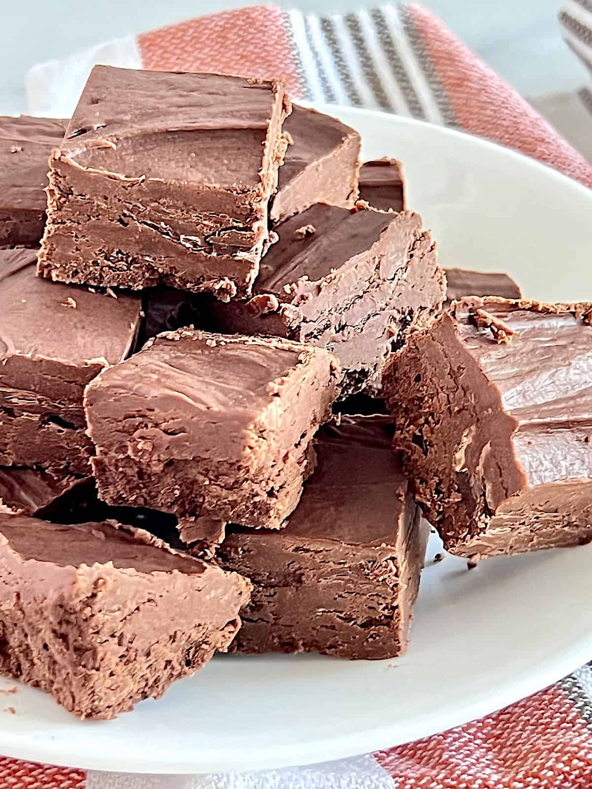 2 Ingredient Frosting Fudge Best homemade Recipe cut into squares on a plate