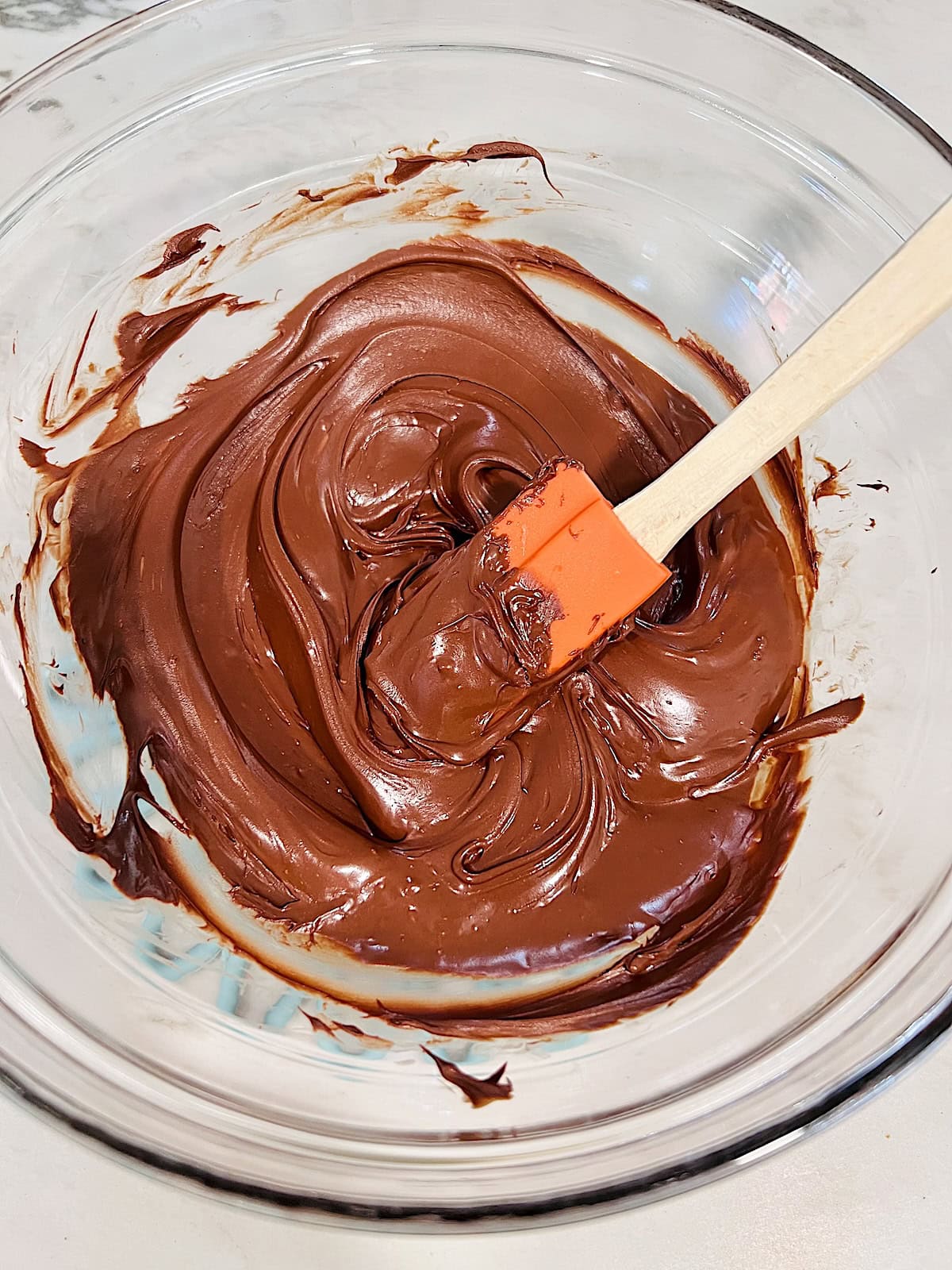 Melted semi sweet chocolate chips in a glass bowl.
