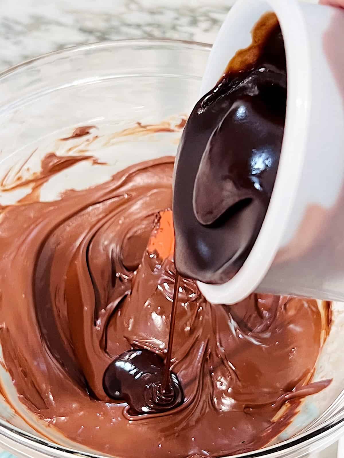 2 Ingredient Frosting Fudge Pouring warm frosting from the can into the bowl of chocolate.