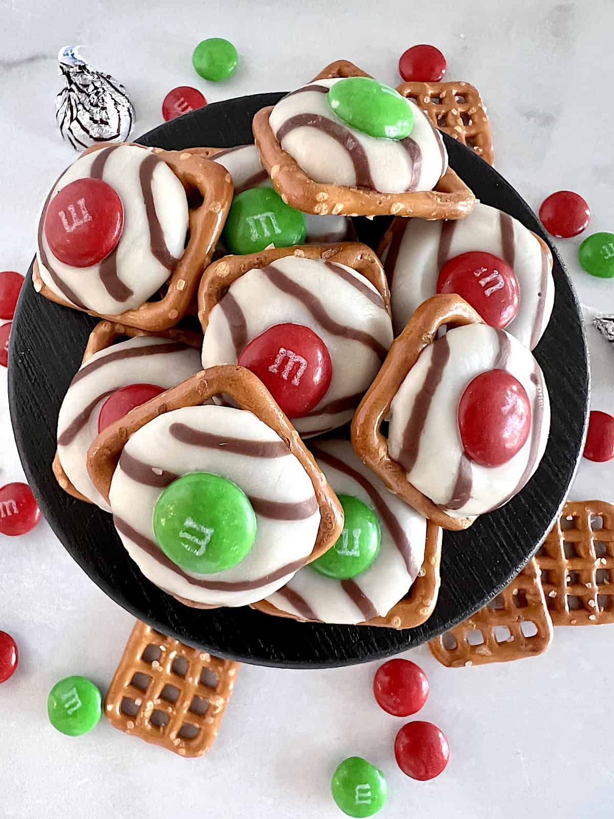 Christmas Pretzel Bites Best Recipe snaps topped with hugs and M&M candies.