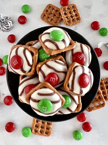 Christmas Pretzel and M&M candy treats stacked ready to eat.