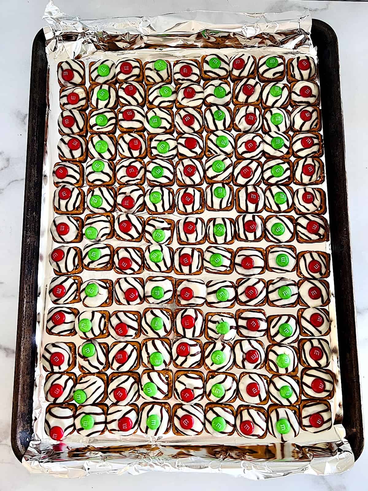 Christmas Pretzel Bites M&M added on top of hugs and pretzels after melting in oven.