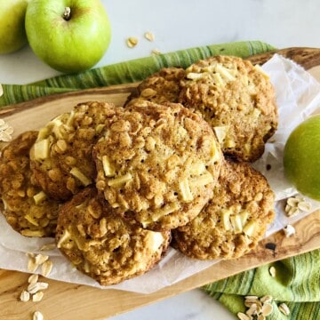 Soft and Chewy Apple Oatmeal Cookies stacked on a serving board.