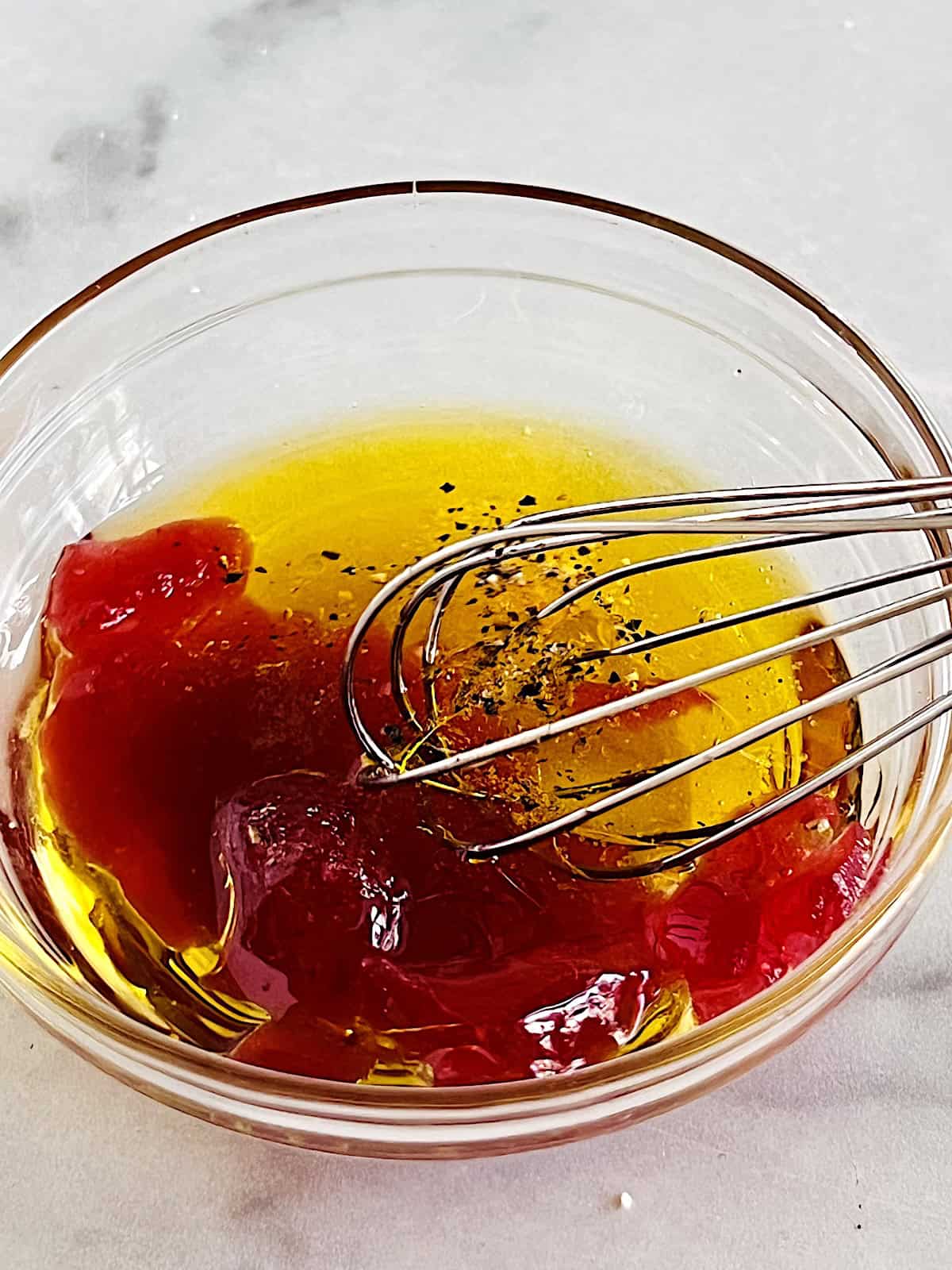 Cranberry Dressing ingredients in a bowl with whisk.