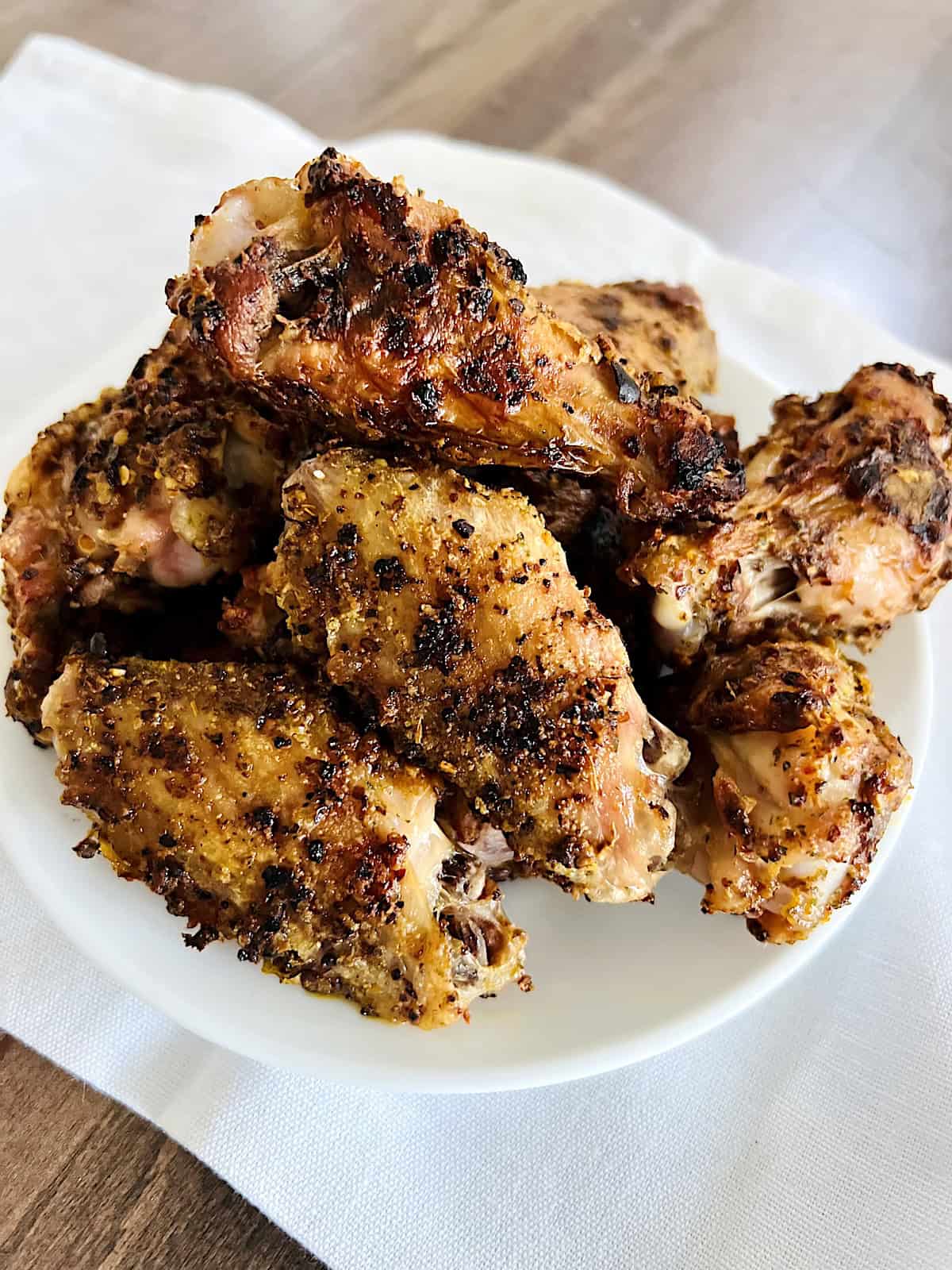 How to Cook Chicken Wings in the Oven Best Crispy Skin Recipe with herbs and spices (gluten-free) ready to eat on a plate.