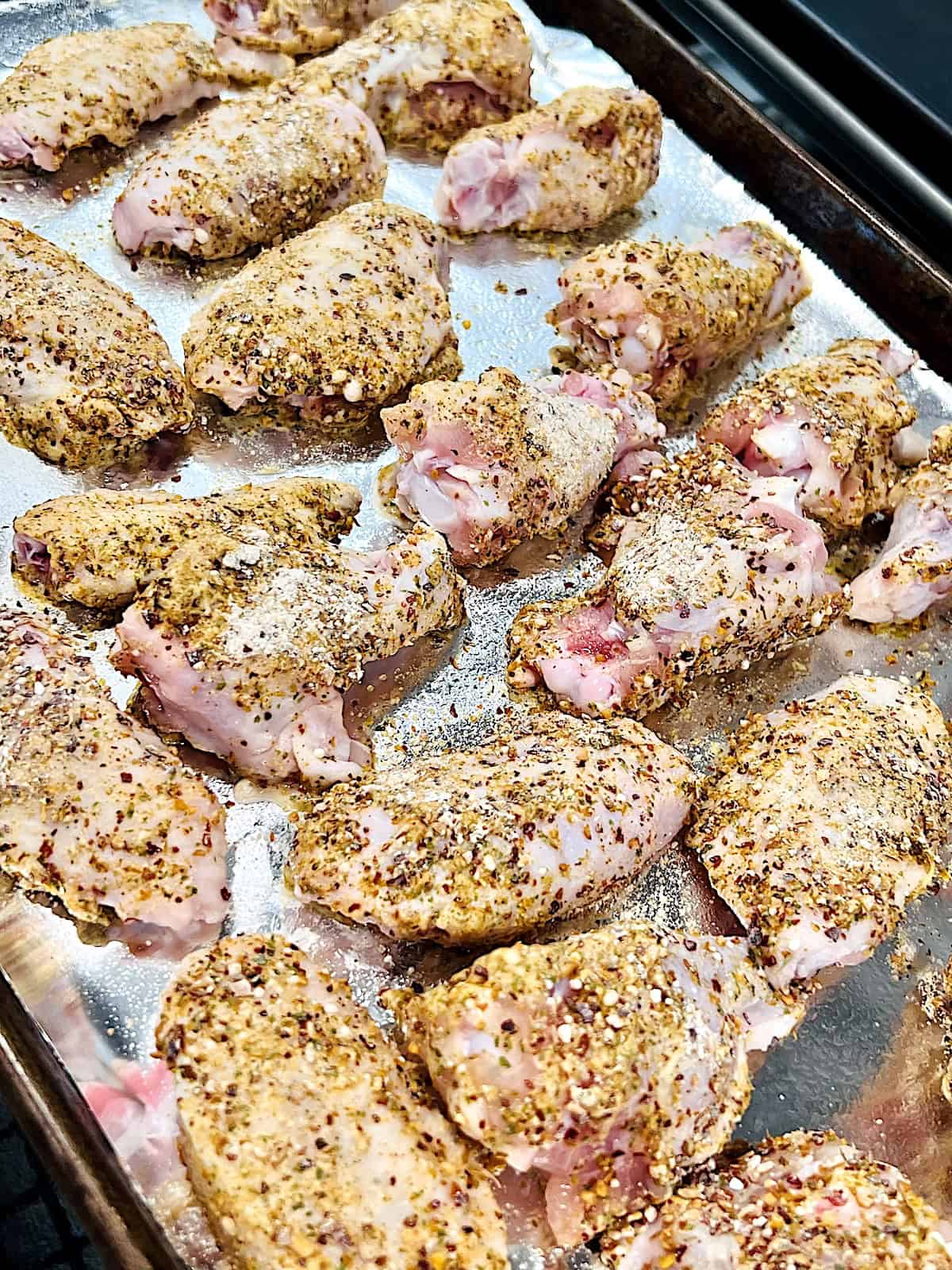 Wings Coated in spices and baking powder ready to bake in the oven