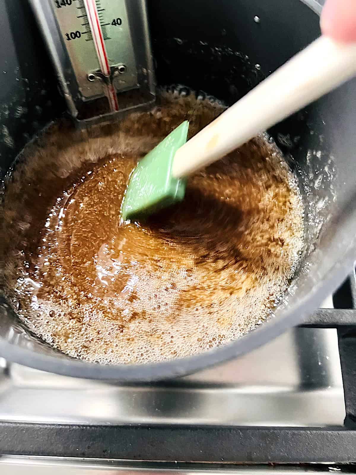 Mixing brown sugar and butter in a pot