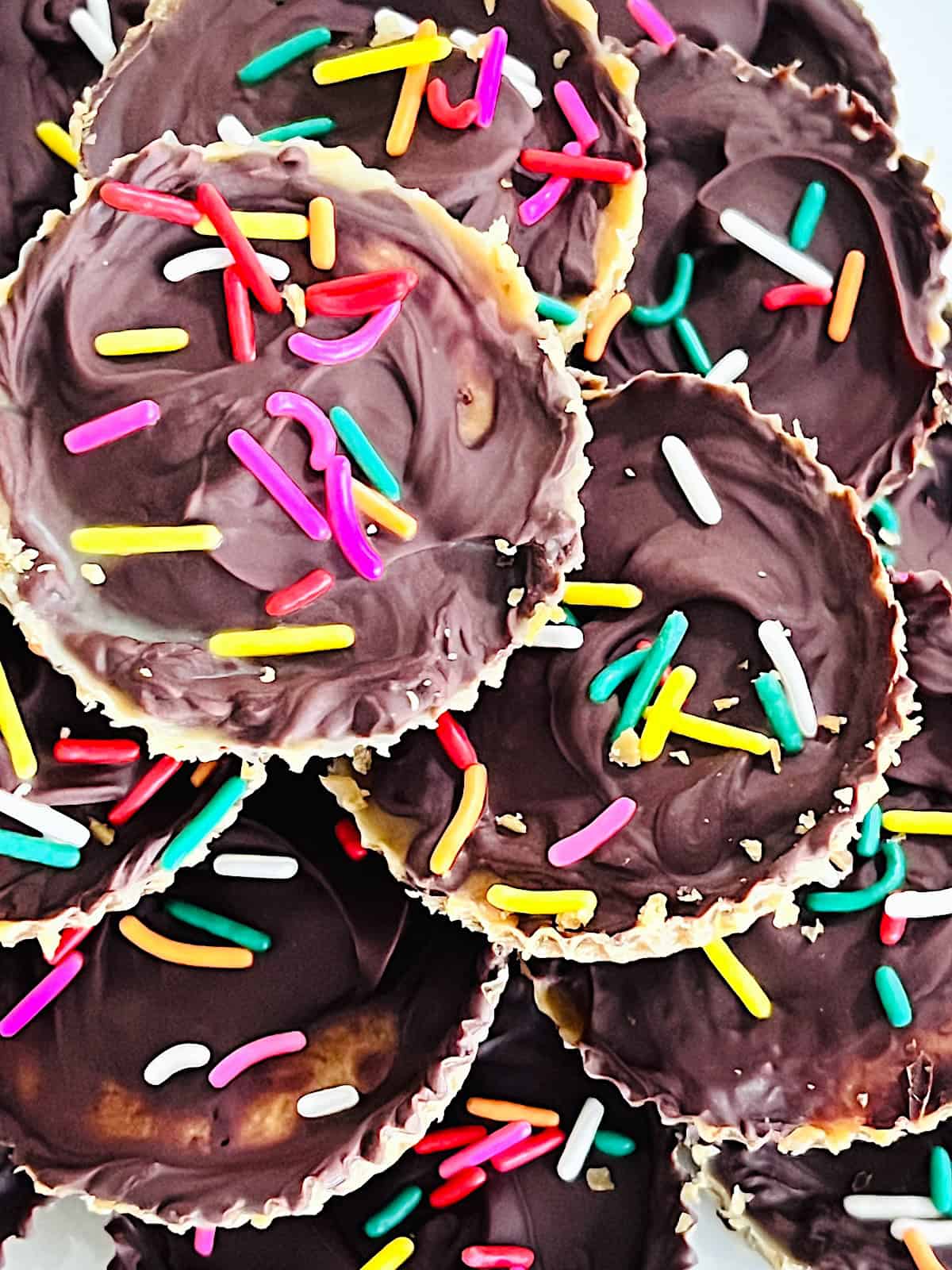 Ritz Cracker Toffee Cookies Best Recipe for holiday crack topped with colored sprinkles ready to eat.