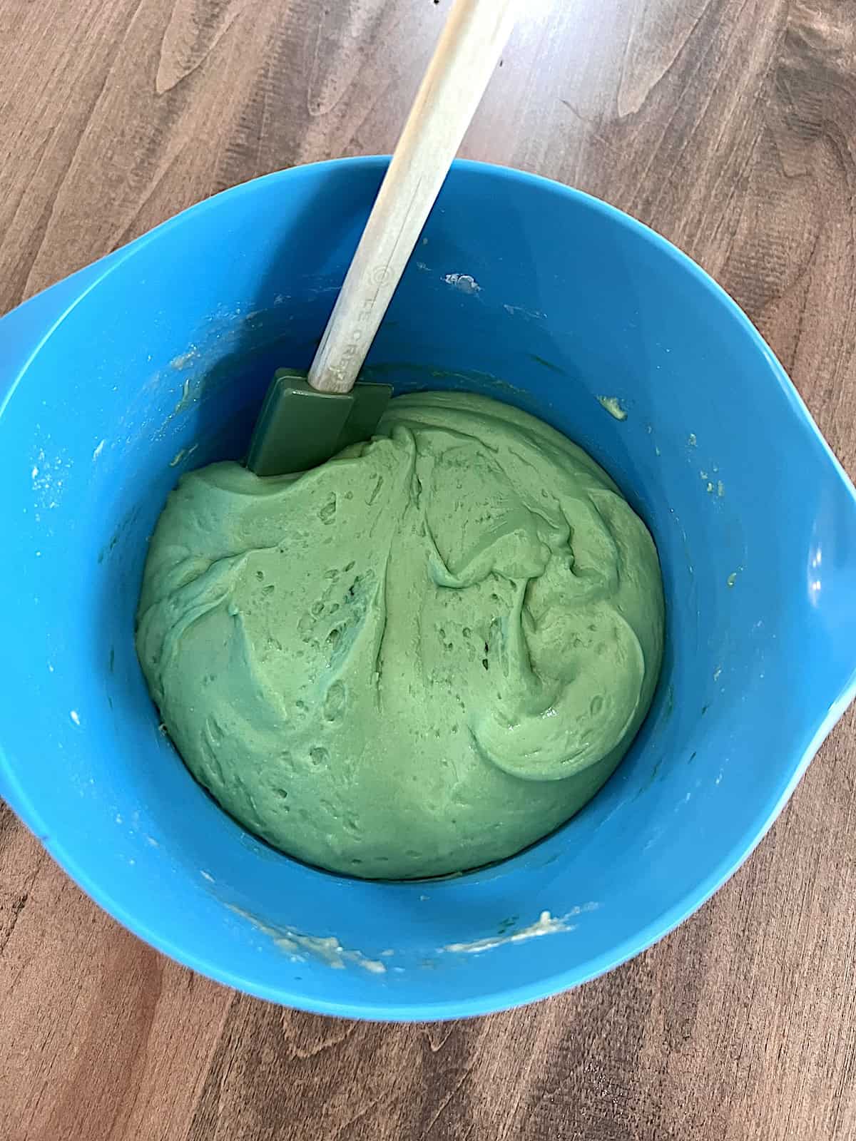 Green cookie dough in a bowl.