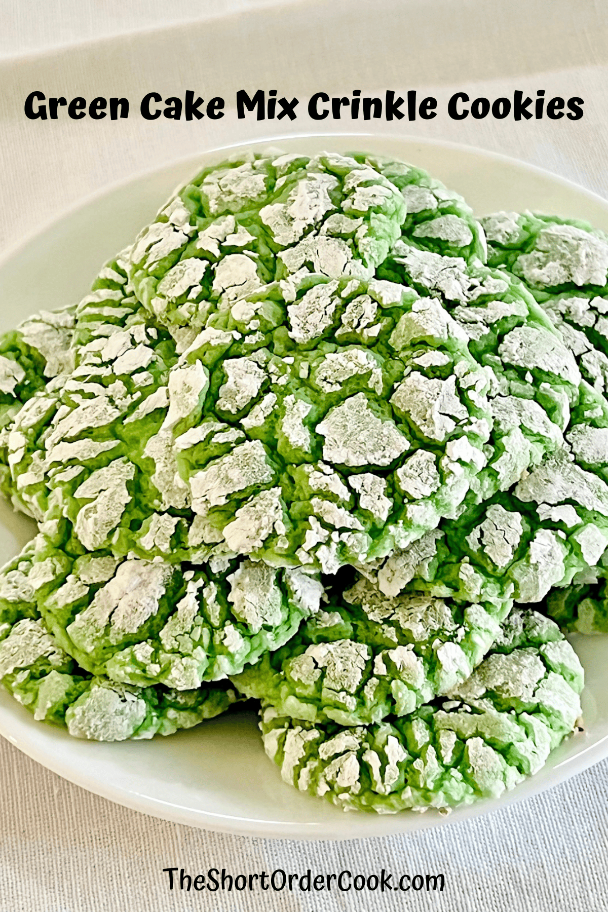 Green Cake Mix Crinkle Cookies stacked on a plate ready to eat.