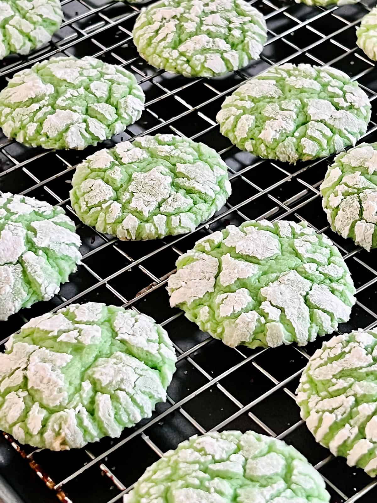 Green Cake Mix Crinkle Cookies Resting on wire rack.