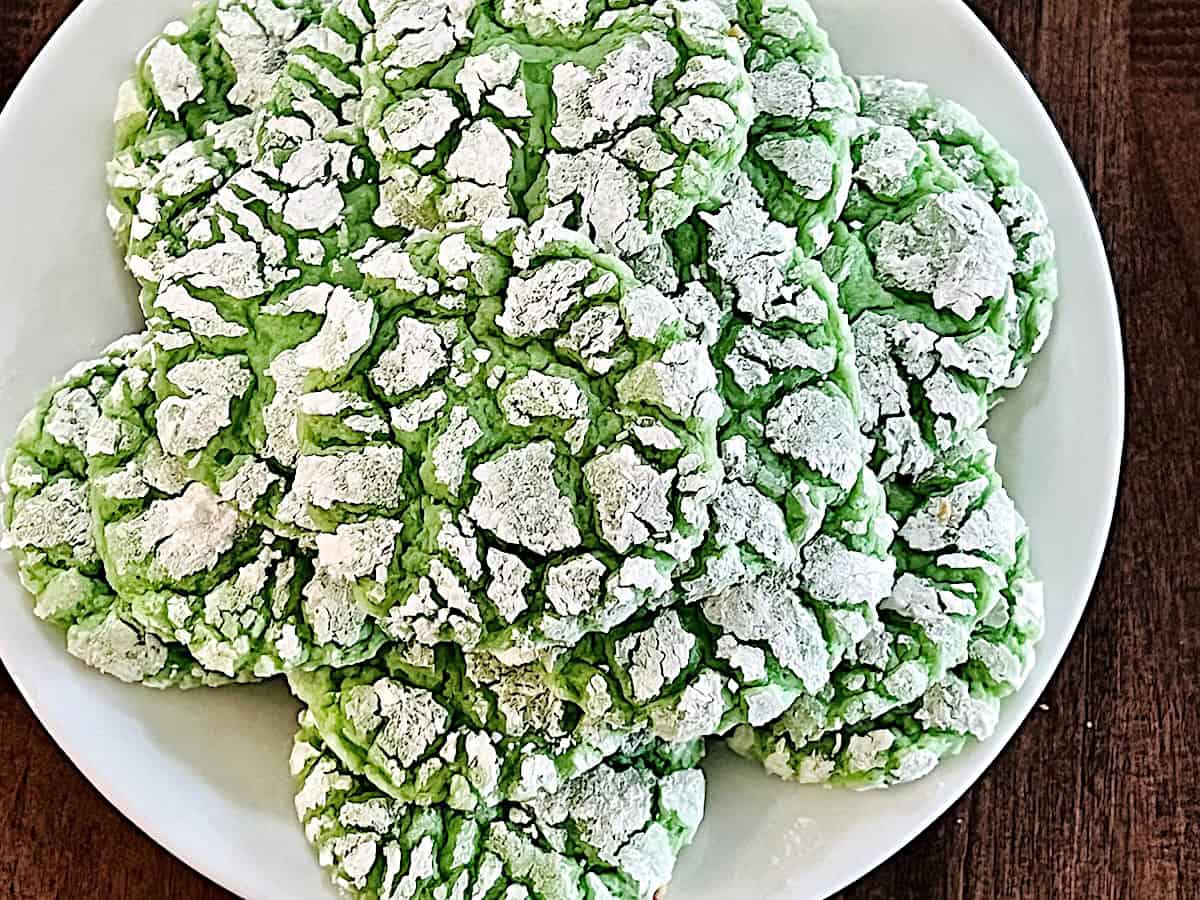 Green Cake Mix Crinkle Cookies stacked on a plate.